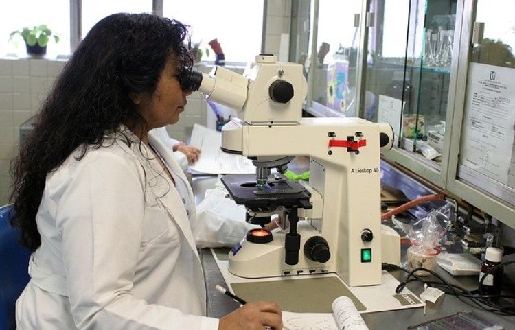 Woman looking through a microscope