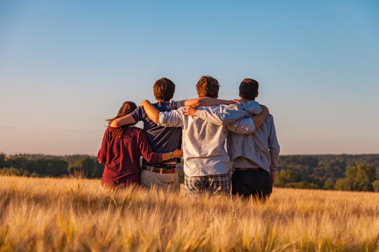 People hugging each other in a field