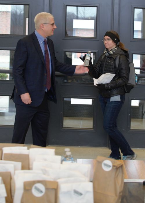 College of Agriculture and Natural Resources Dean Ron Hendrick hands a Snacks for Success care package to a student during exams.