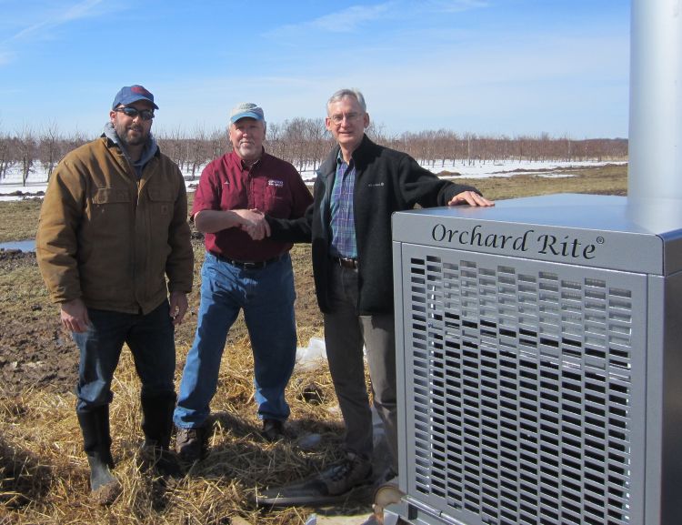 CRC assistant farm manager Dan Platte (left) and MSU professor Gregory Lang (right) thank Lee DeLeeuw for the wind machine.