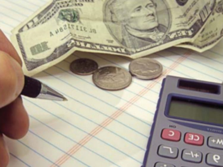 Calculator, a pen, and a $10 bill in a photo.