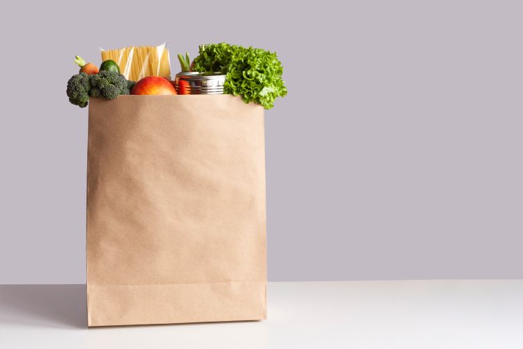 Paper grocery bag filled with produce.
