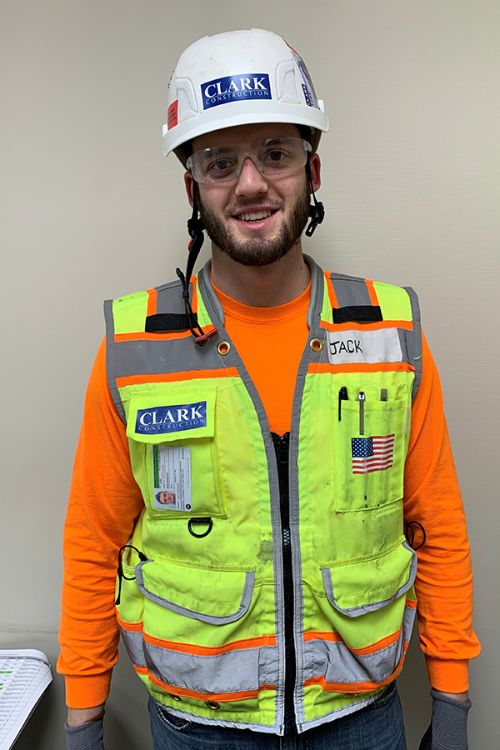 Photo of Jack Brierton wearing construction hard hat and vest.