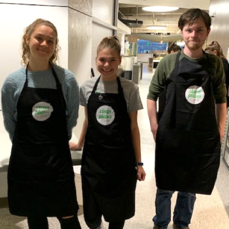 MSU students, two female and one male, in black aprons