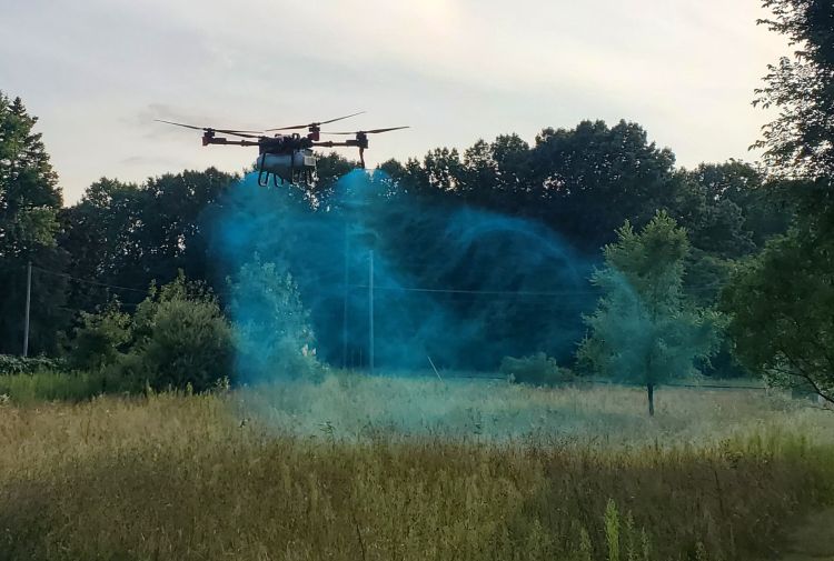 drone spraying grassy area