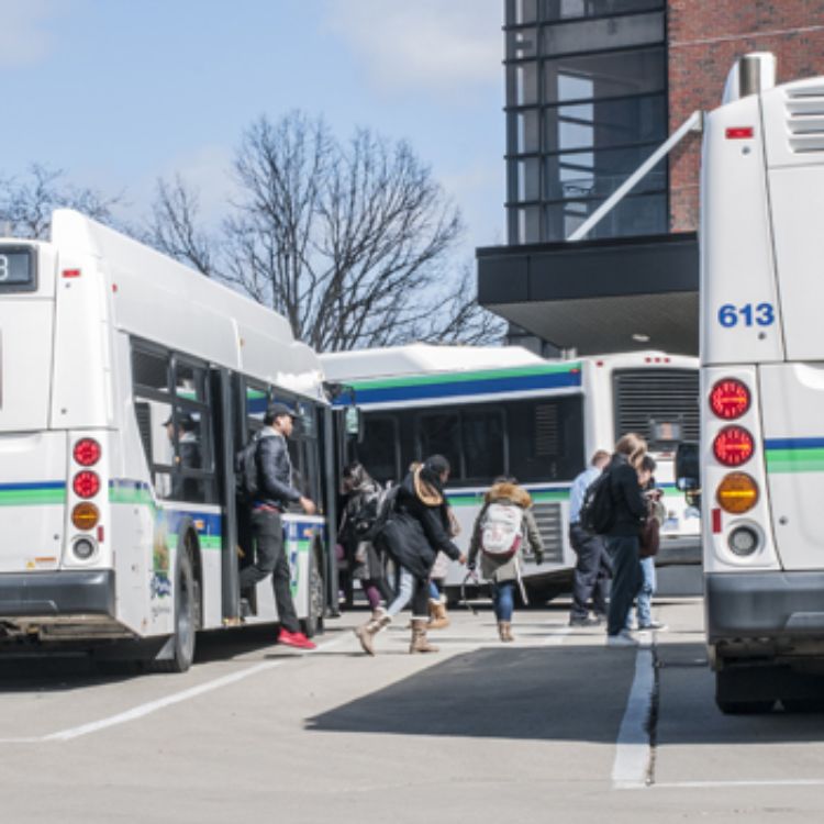 CATA bus riders exiting bus at transit station. Photo by MSU CABS.