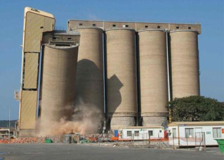Photo of the demolition of a farm silo.