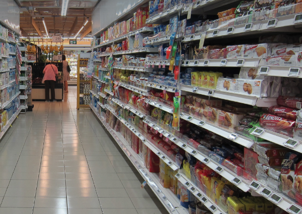 Grocery store aisle with shelves full of processed foods