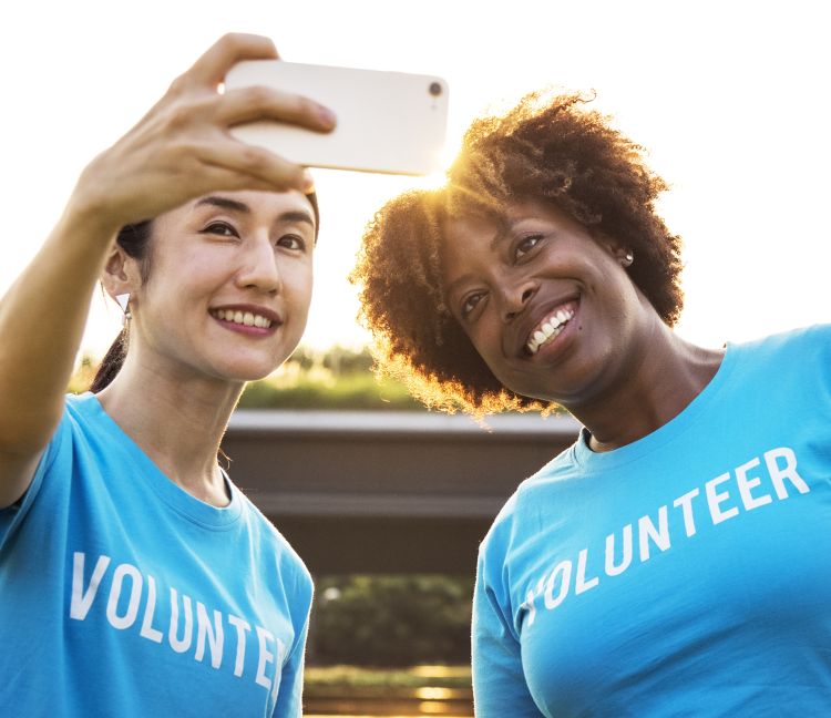 Two women smiling into a cell phone