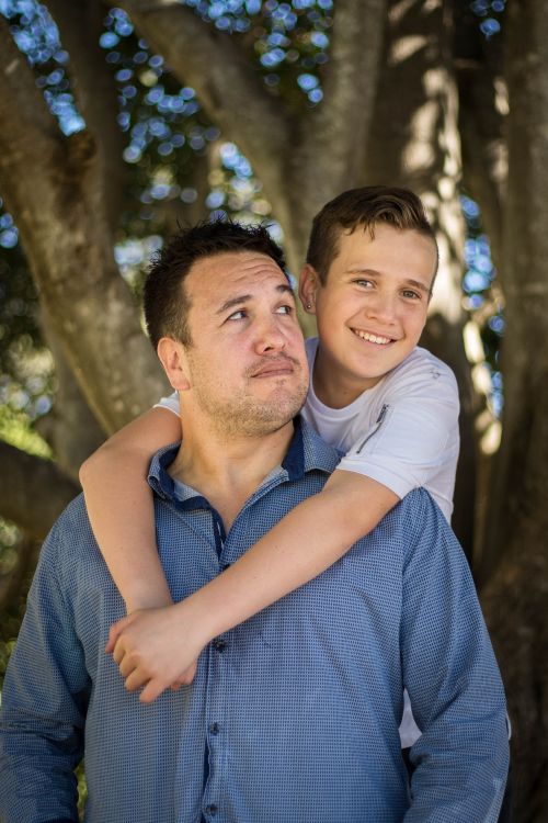 Son hugging father from behind.