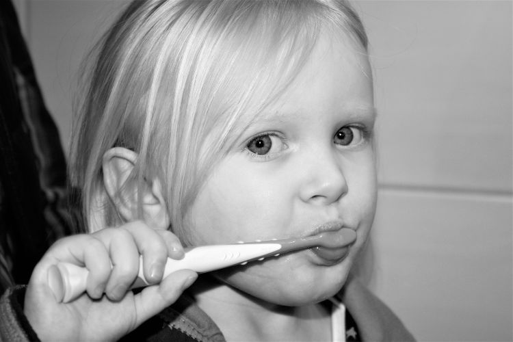 Child brushing her teeth.