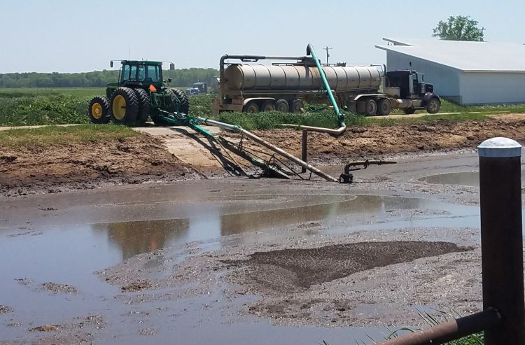 Tractor pumping out of a manure lagoon.