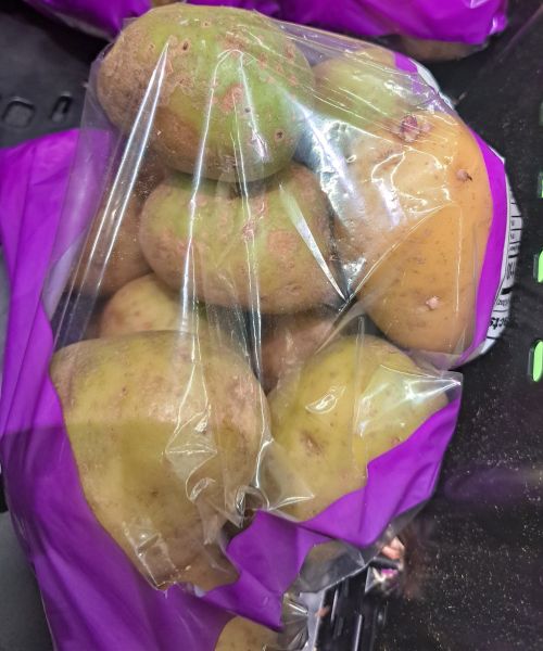 Green potatoes in a bag.