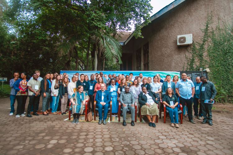 A group of many people posing together in Tanzania.