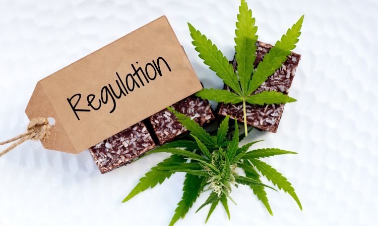 Photo of cannabis plant leaves, brownies, and a tag labeled regulation.