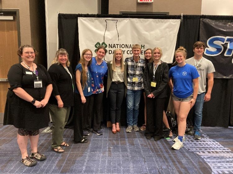 Members of the Michigan delegation outside a banner that says National 4-H Dairy Conference.