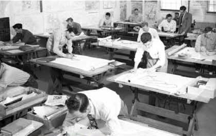 Photo of Landscape Architecture students working in a lab environment on drafting tables in MSU's old Quonset huts.