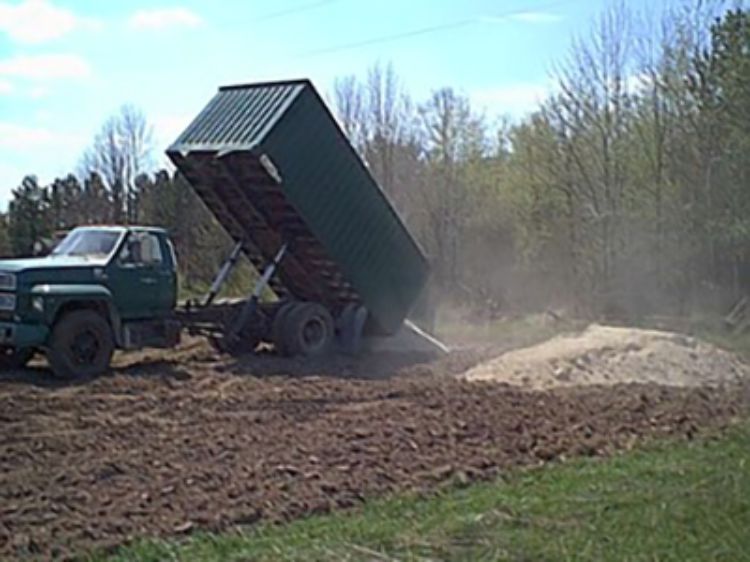 Dumping lime from truck in Ontonagon for MSU trial.