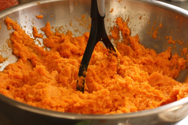 Mashing up sweet potatoes for a sweet potato casserole can be a great task for kids helping in the kitchen. Photo by Meal Makeover Moms, Flickr Creative Commons
