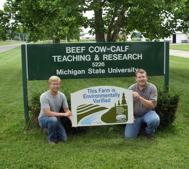 Dr. Dan Buskirk and undergraduate student pose with new sign.