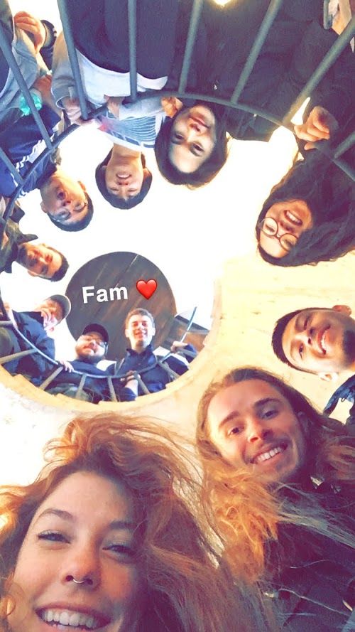 Students and faculty standing in a spiral staircase in a group shot.