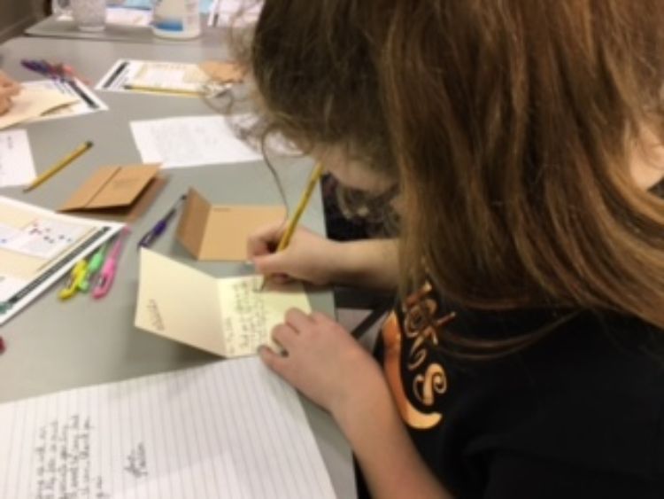 Youth writing a thank-you note