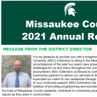 front cover page of the annual report with green background, title in white, bold font and a note by the district director