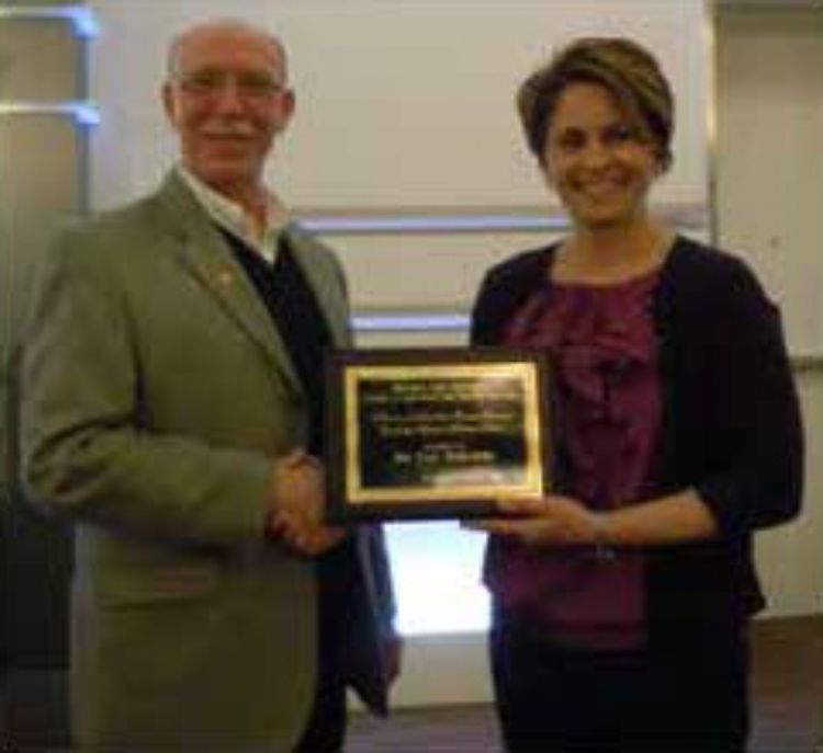 Photo of Paul Nieratko receiving the 2013 Howard and Lili Camden Teacher/Scholar Award from Dr. Kelly Millenbah.