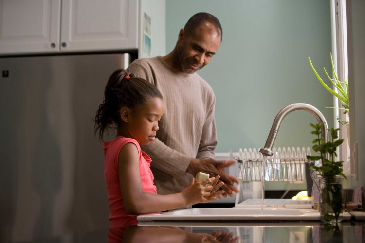 Man and girl washing hands