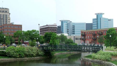 Photo of a river, bridge, and a city skyline.