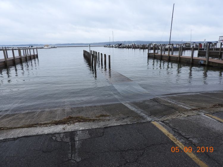 High lake levels are seen at Elmwood Township Marina Boat Launch in Michigan's Leelanau County. The water is rising onto the boat launch driveway area.