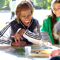 Youth and adult conducting an experiment