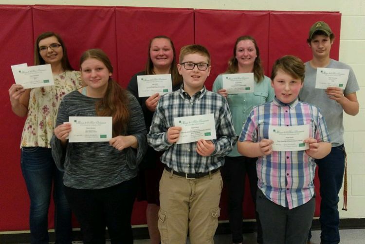 4-H youth receive award pins and certificates.