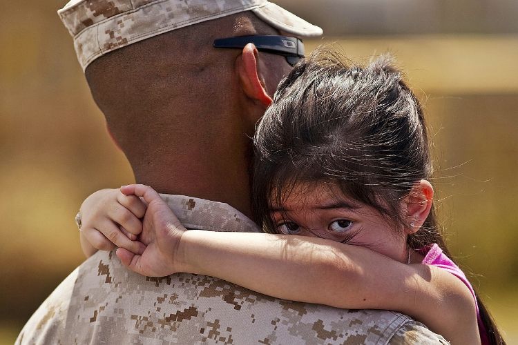 Girl hugging a soldier