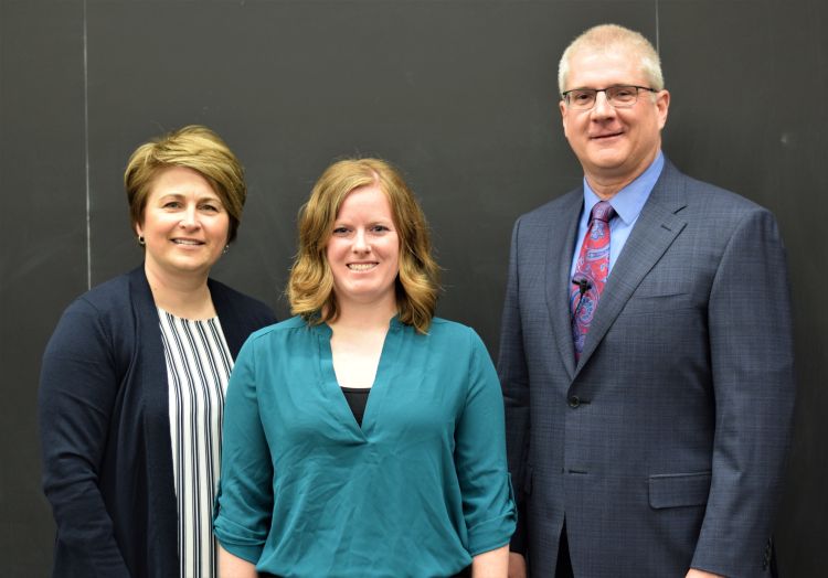 CANR Senior Associate Dean Kelly Millenbah and CANR Dean Ron Hendrick present the Excellence in Graduate Student Teaching Award to Carley O'Malley (center) from the Departments of Animal Science.
