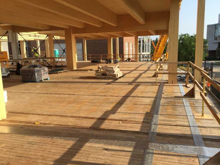 Michigan State University's STEM Teaching and Learning Facility under construction. View of glue-laminated columns, beams, and girders and cross-laminated timber floor and ceiling panels.
