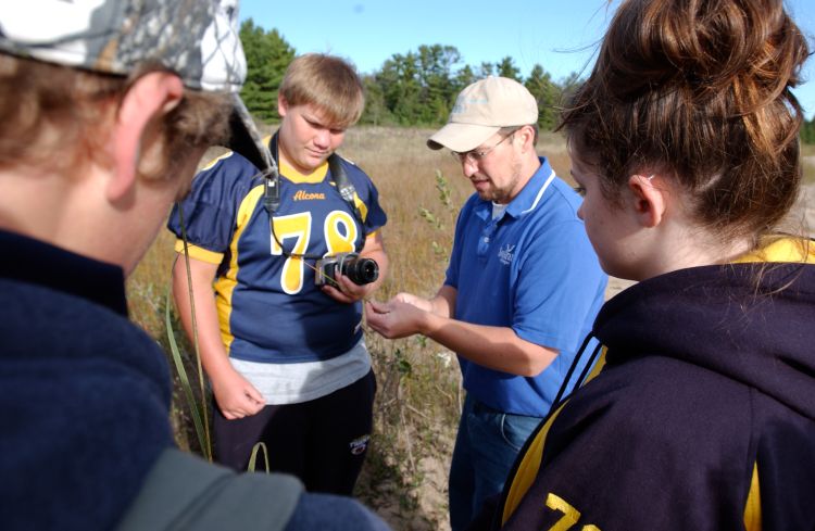 Brandon Schroeder works with youth during a place-based education program. Michigan Sea Grant