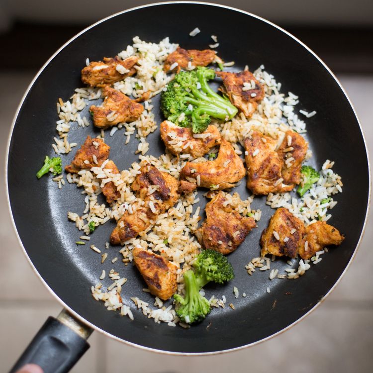 Chicken, broccoli and rice leftover in pan.