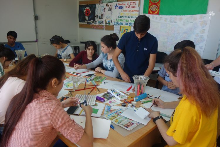 Turkmenistan visitors draw pictures for the international art and handcrafting project.