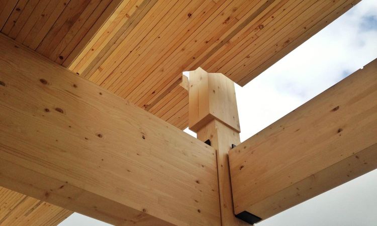 Glulam beams with blue sky in the background.