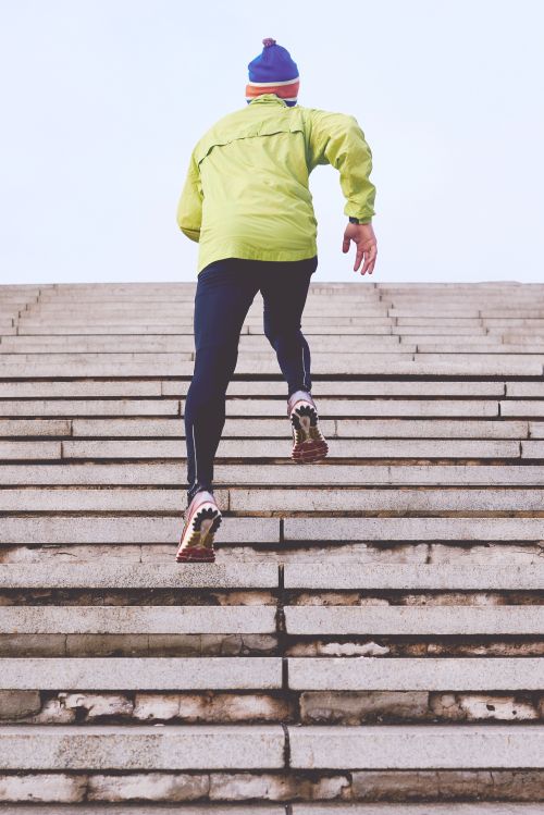 Man exercising by running up stone steps.