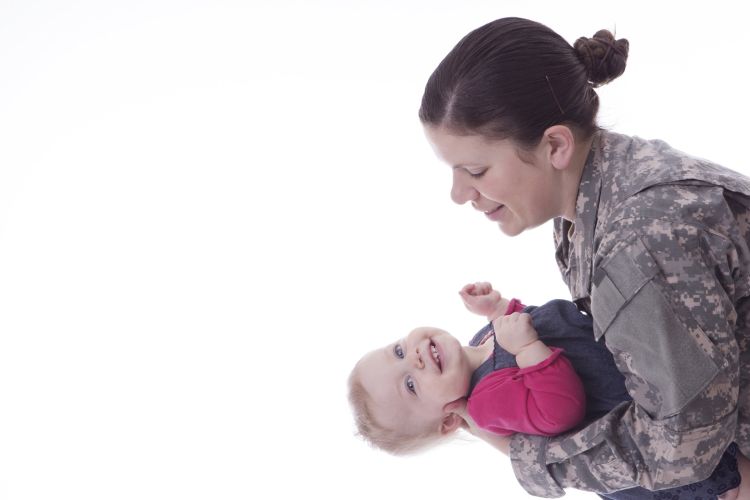 Military mom holding daughter