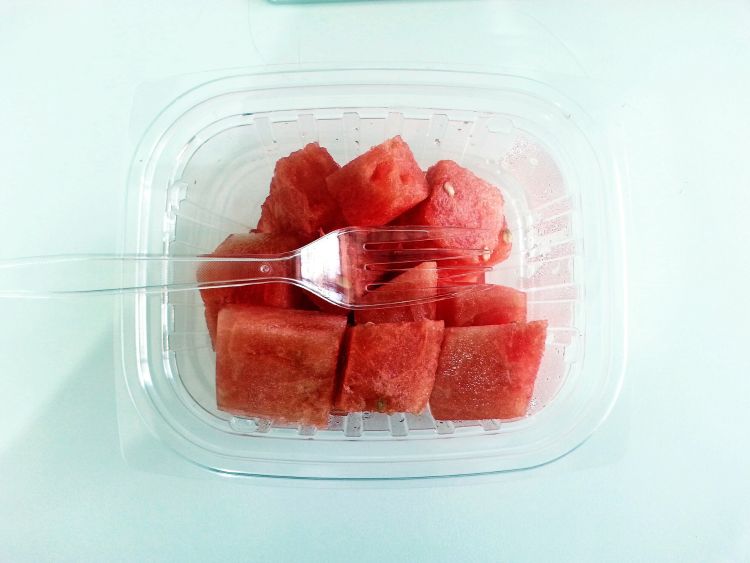 Watermelon in a plastic tub.