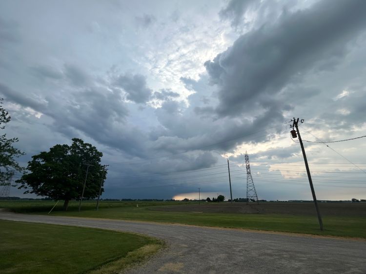Dark and cloudy skies over a field.