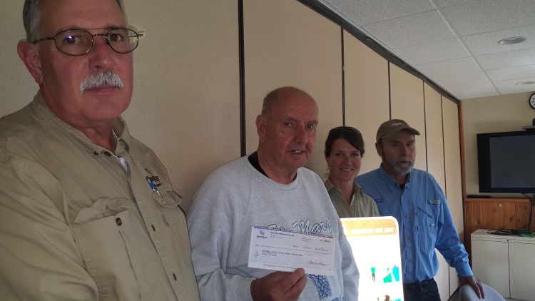 Travis Brown’s father Mike Brown (left) presents a check from Rieth-Riley Construction Co. Inc., to his father Wayne Brown, chairman of the Mackinac County Water Safety Review Team to be used for water safety projects.  Photo: Kathleen Arndt 