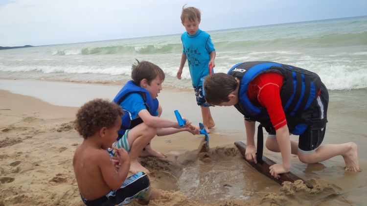 Children play on the shore of Lake Michigan. | Photo by Monica Day