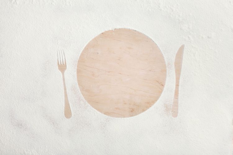 Silhouette of plate, fork, and knife.