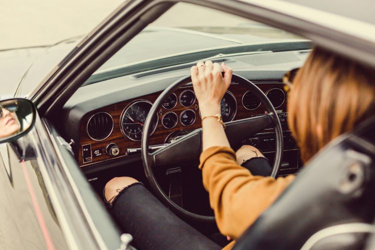 Woman driving a car | Photo by Matthew Henry