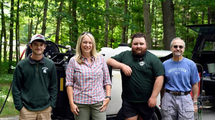 Four people from the Mobile Boat Wash Program with Michigan State University Extension.