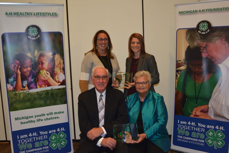 GreenStone Farm Credit Services representatives with Dale and Sara Stuby receiving Michigan 4-H Citation Awards.